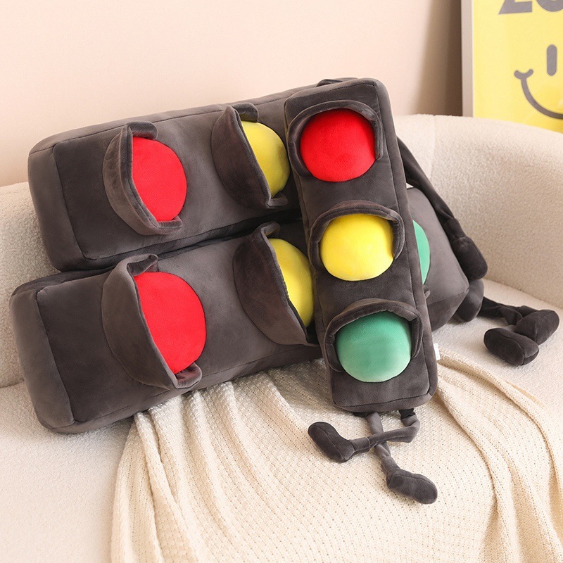 Traffic light plush pillows stacked on a sofa, long soft cushions with red yellow green lights, cozy plush fabric pillows for hugging and home decor
