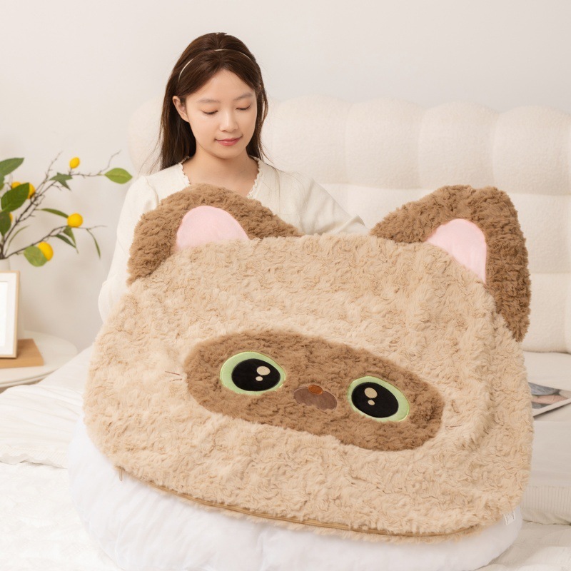 Siamese Cat plush pillow in soft textured fabric held as a comfortable backrest cushion, cute cat head design for bed or sofa use and cozy home decor