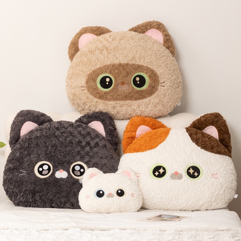 Cartoon cat head plush pillow in multiple sizes on bed, including Calico Cat, Black Devon Rex Cat, White Devon Rex Cat, and Siamese Cat designs, soft backrest cushion for bedroom use