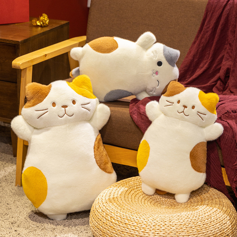 Calico cat plush pillow displayed in cozy home setting, soft and fluffy cat cushion for sofa decor, hugging, lounging, and relaxing comfort