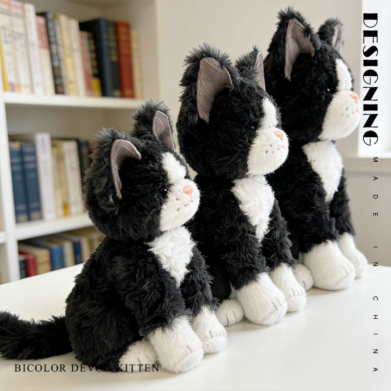 Bicolor Devon Rex cat plush toy with upright sitting shape and big ears, side view showing soft plush fabric and detailed stitching