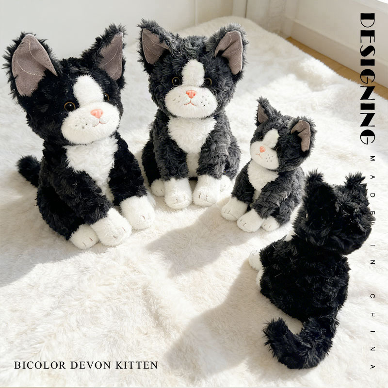 Bicolor Devon Rex cat plush toy in different sizes arranged on a soft fluffy rug, showcasing playful design and cozy home atmosphere