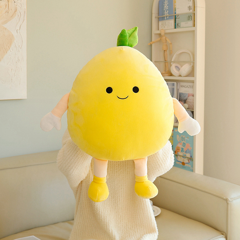 Pomelo plush pillow with soft yellow fabric, cute embroidered face and leaf detail, shown in a front view highlighting its full shape and plush texture