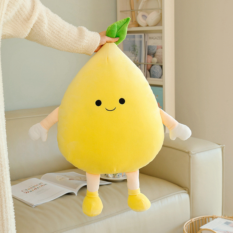 Pomelo plush pillow with soft plush fabric and leaf detail, lifted to show its lightweight feel and natural shape with smooth and cushioned texture