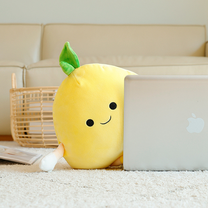 Pomelo plush pillow used as a soft cushion against a laptop, providing comfortable support for lounging, reading, or casual use at home