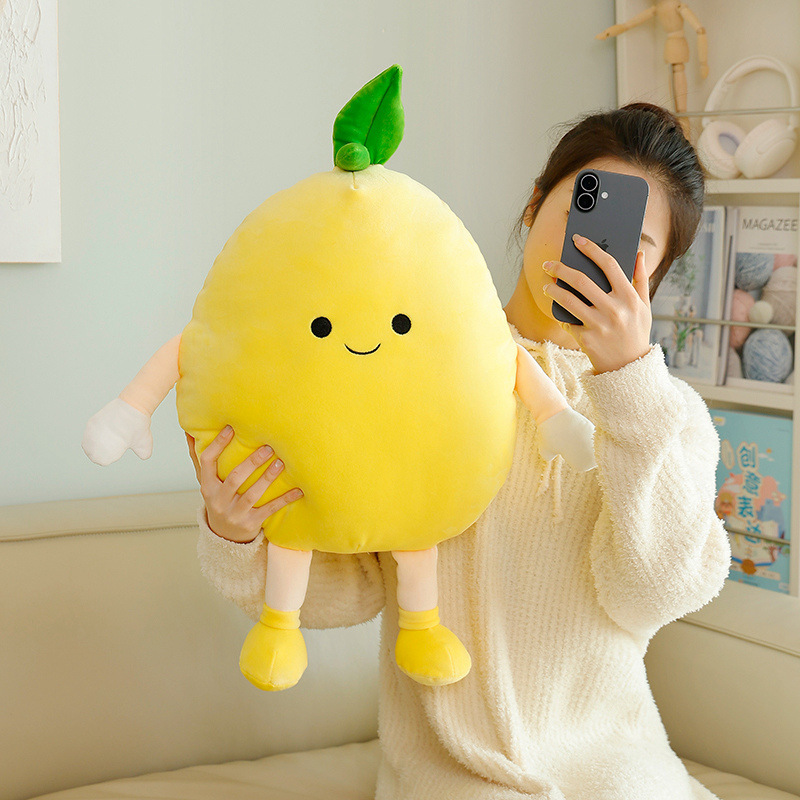 Pomelo plush pillow with soft filling and rounded shape, held upright to show its size, smooth texture, and cozy cushion design for everyday use