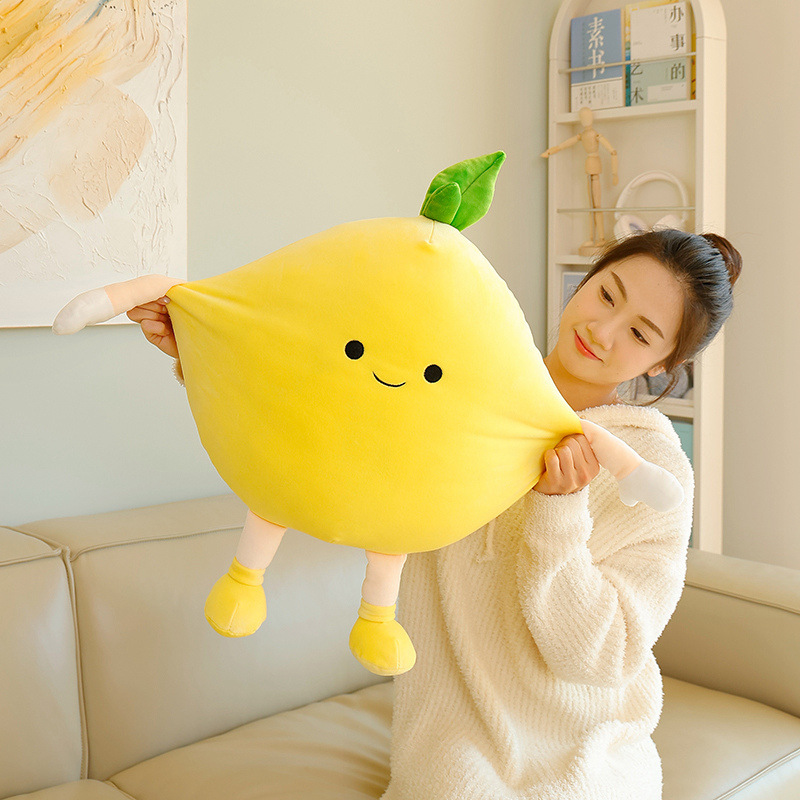 Pomelo plush pillow with flexible shape gently stretched to demonstrate its soft filling, elasticity, and comfortable plush texture for everyday use