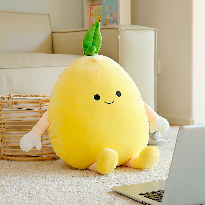 Pomelo plush pillow with soft yellow fabric and cute face, placed on the floor beside a sofa, creating a cozy and relaxed home setting