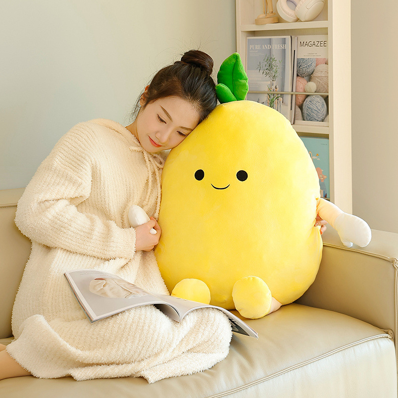 Pomelo plush pillow with soft yellow fabric and cute face, used as a cozy cushion for relaxing and reading on a sofa in a warm home setting