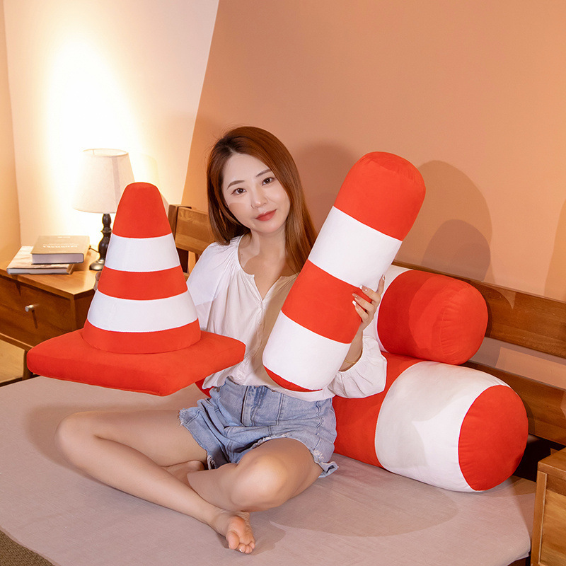Traffic cone plush pillow in cone and bolster shapes, soft striped cushion for hugging, resting, or cozy home styling