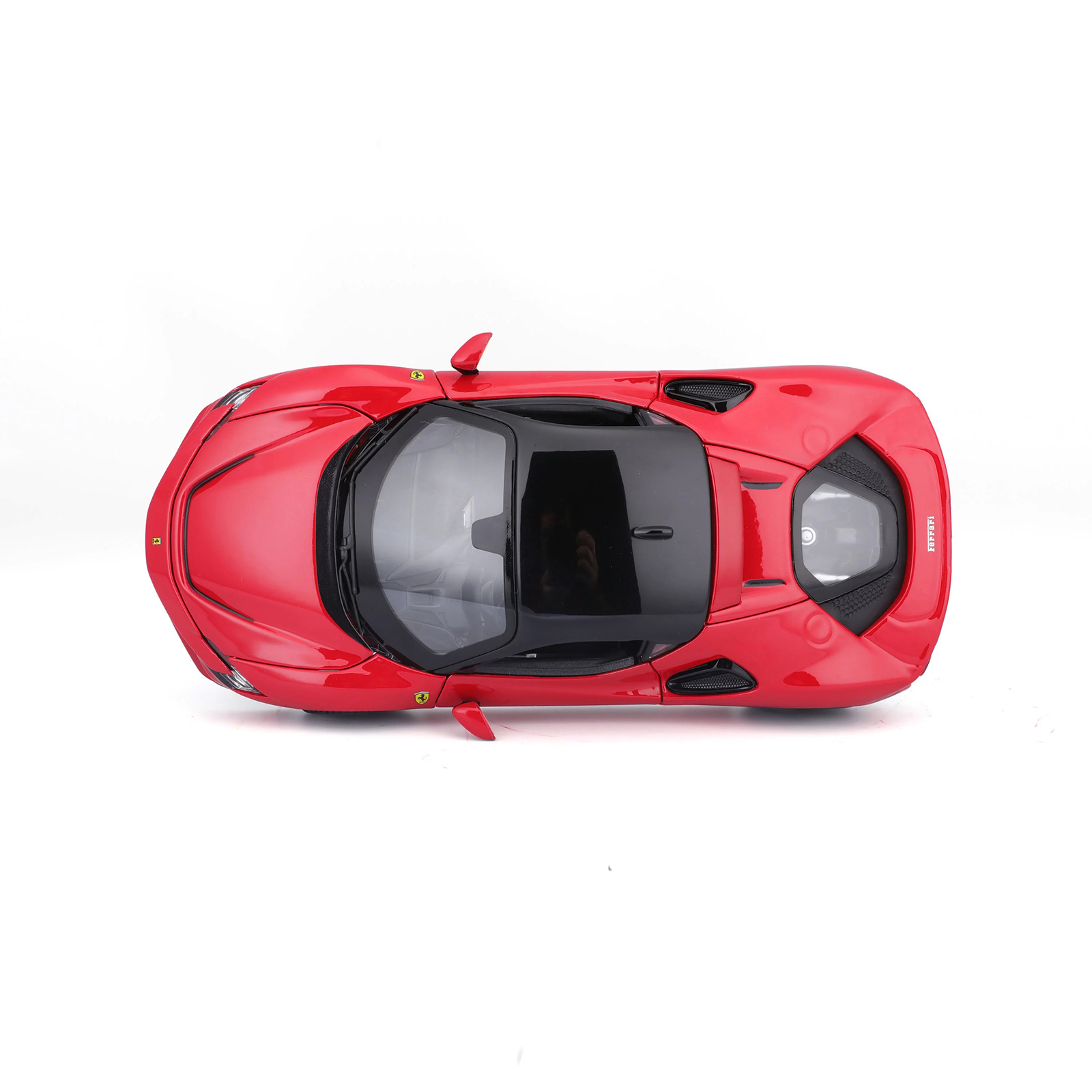Ferrari SF90 Stradale red 1:24 diecast model car top view, showing black roof, engine cover details, and aerodynamic design