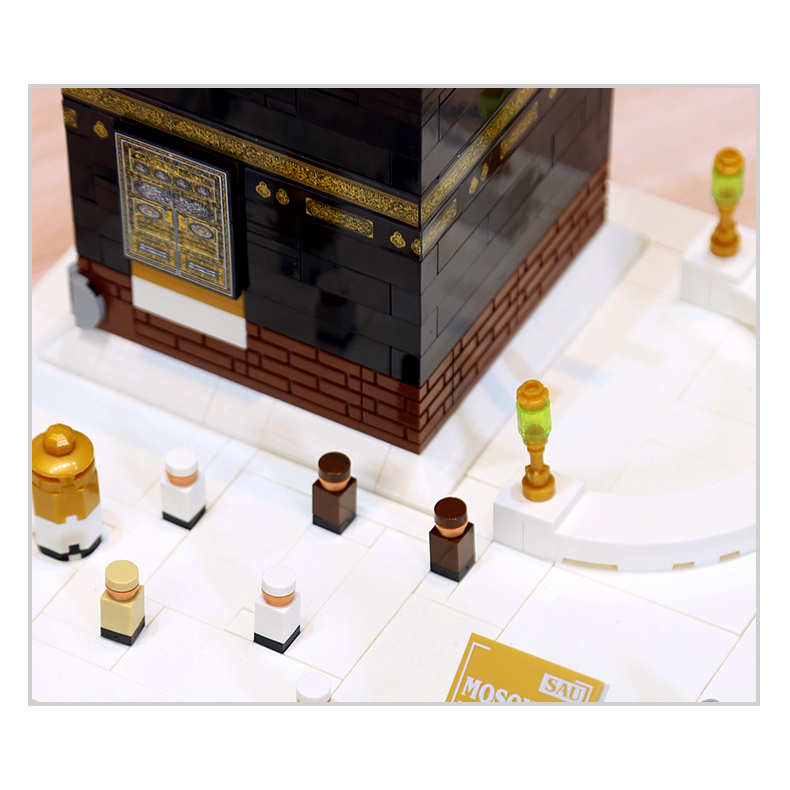 Kaaba building blocks model close-up featuring detailed gold door design, textured brick base, and miniature courtyard scene