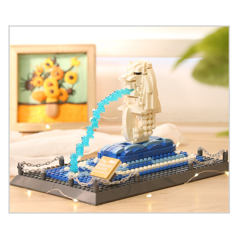 WANGE Merlion Statue Singapore building blocks model displayed on tabletop with warm lighting, showcasing decorative appeal, water feature design, and home display atmosphere