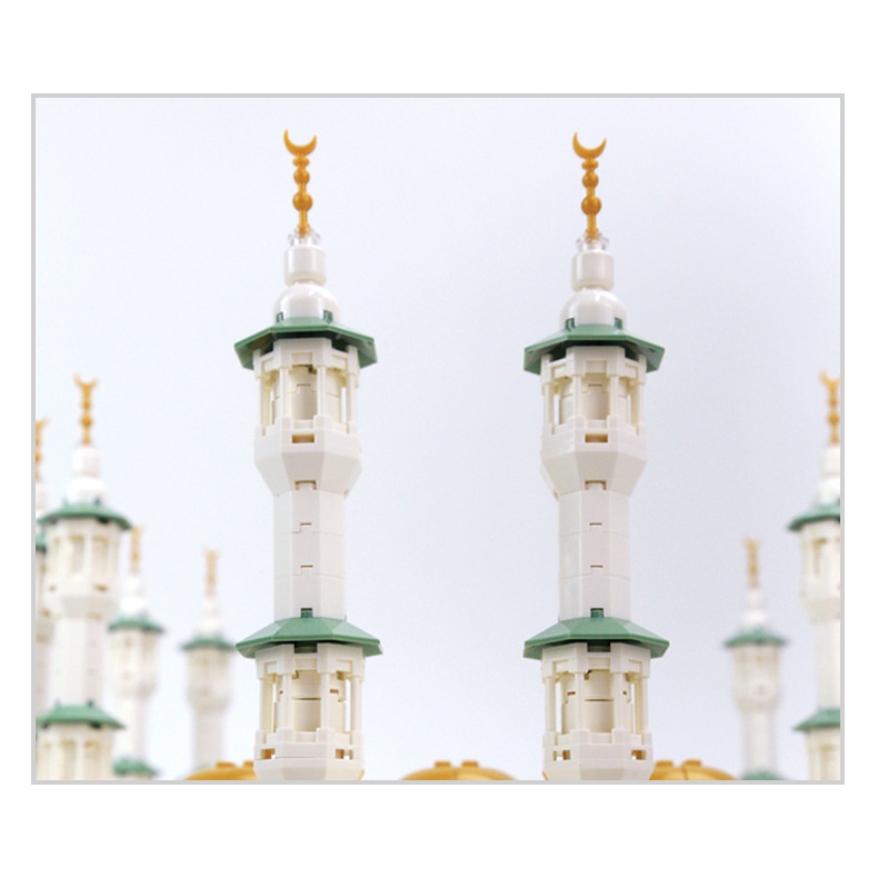 Great Mosque of Mecca building blocks model close-up of minarets with detailed structure, green accents, and crescent finials