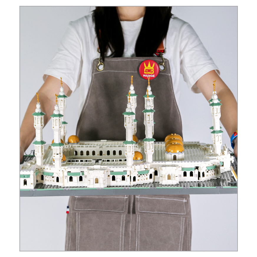 Great Mosque of Mecca building blocks model with detailed minarets, arched walls, and golden domes, presented as a completed architectural display piece