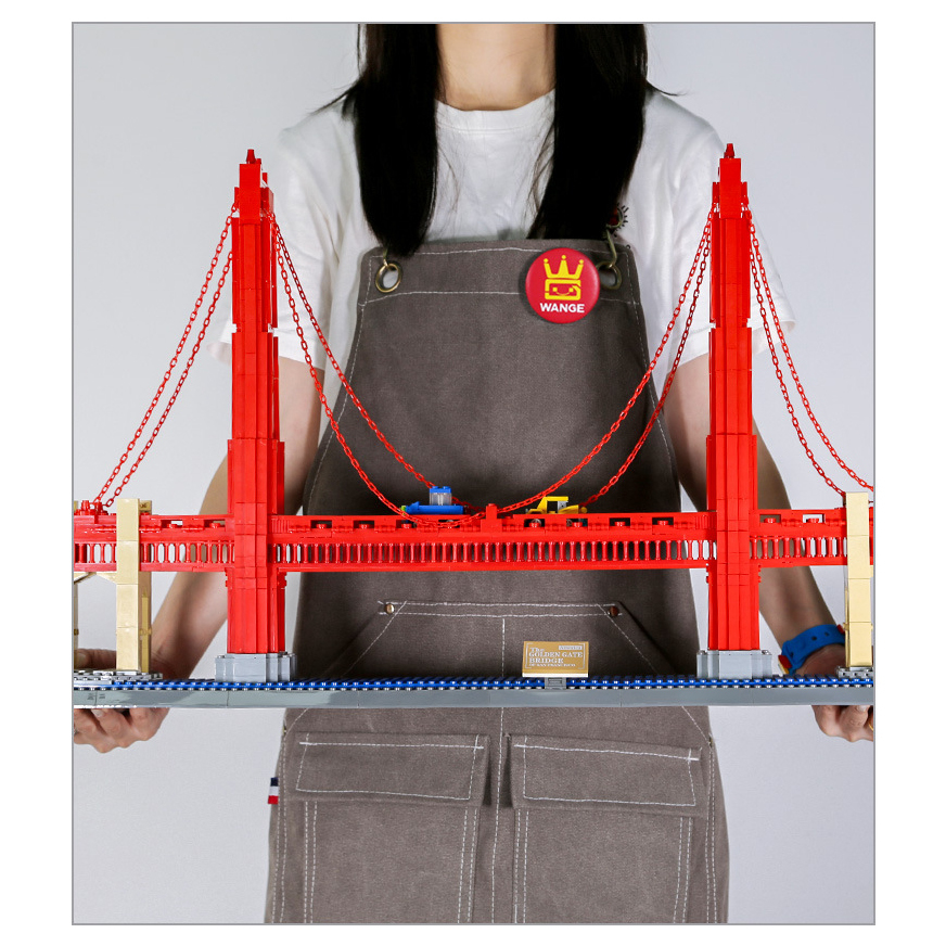 Golden Gate Bridge building blocks model with red towers and suspension cables, displayed on base to show scale, structure, and detailed architectural design