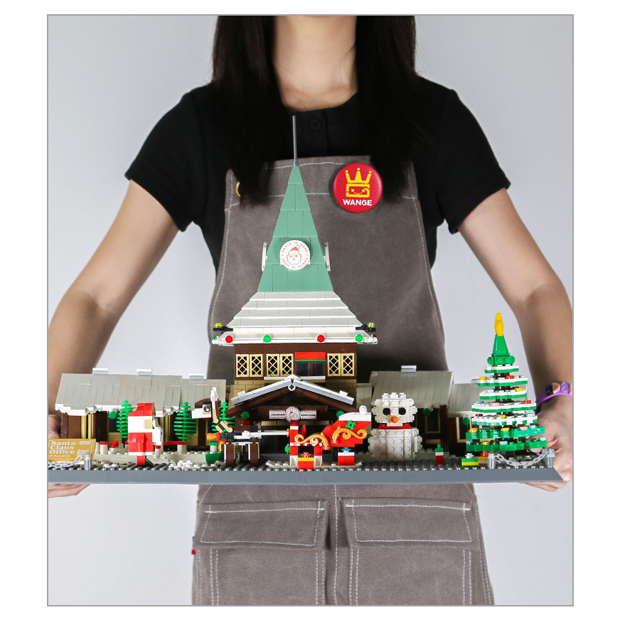 Santa Claus Office building blocks assembled model held for scale, featuring winter house, Christmas tree, sleigh and festive display details