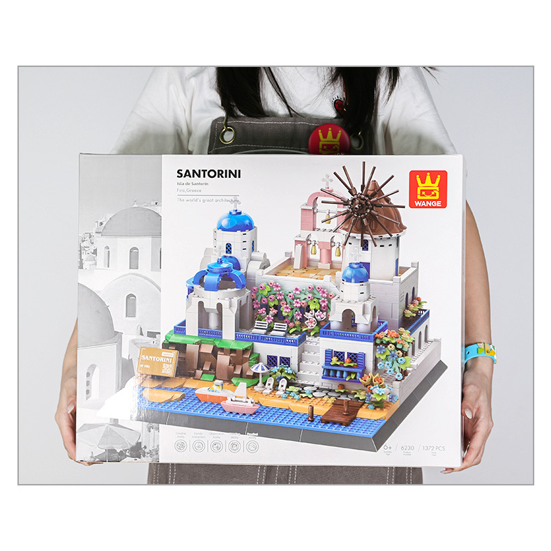 Santorini building blocks set in retail packaging box, showcasing detailed Mediterranean architecture model with layered terraces and seaside design