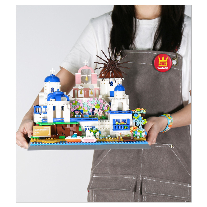 Santorini building blocks model display with white and blue buildings, windmill, floral details, and coastal base, ideal for desk or shelf decoration
