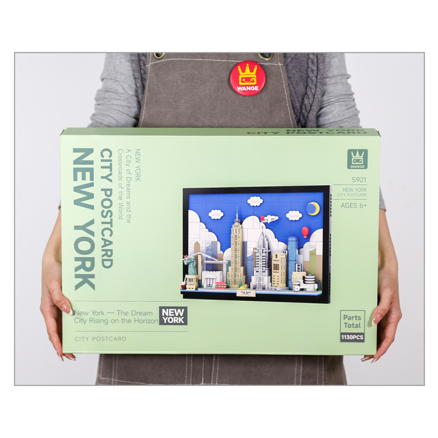 WANGE New York City Postcard building blocks set box held for scale, showing packaging design, city skyline artwork, and product size reference