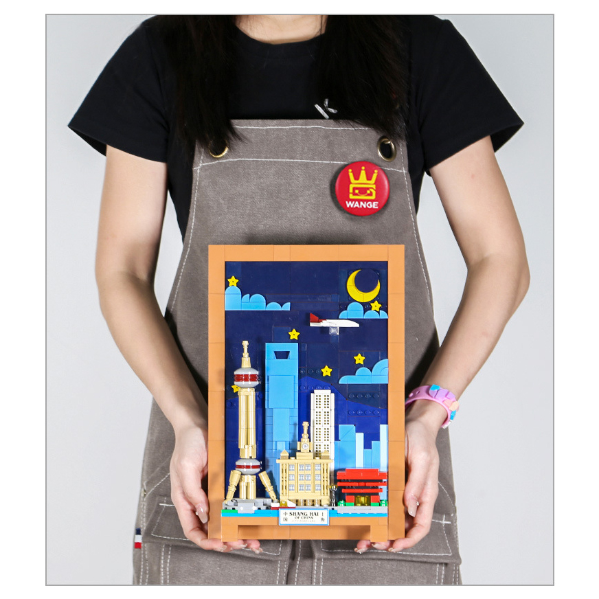 Shanghai City Postcard building blocks assembled model held upright, featuring framed skyline with Oriental Pearl Tower, night sky elements, and compact display size