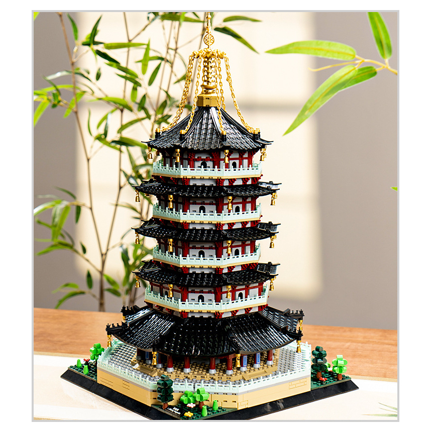 Leifeng Pagoda building blocks model displayed on table with layered tiers, golden spire, and traditional Chinese architecture design