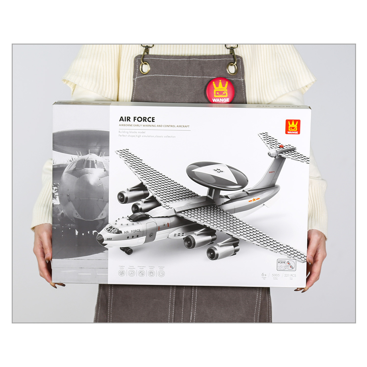 AWACS aircraft building blocks box held for size reference, featuring Air Force design and radar dome aircraft illustration