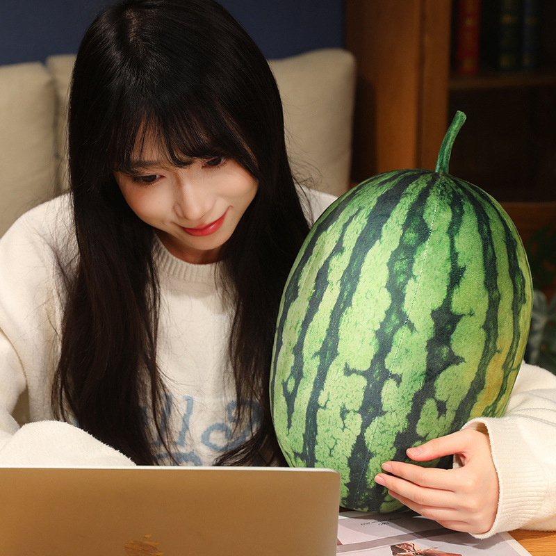 Realistic watermelon plush pillow beside a workspace for cozy and relaxing desk comfort