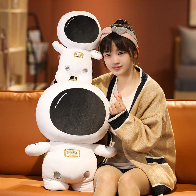 Astronaut plush toy in different sizes with soft plush texture and cozy space-themed design for home decor and gifting