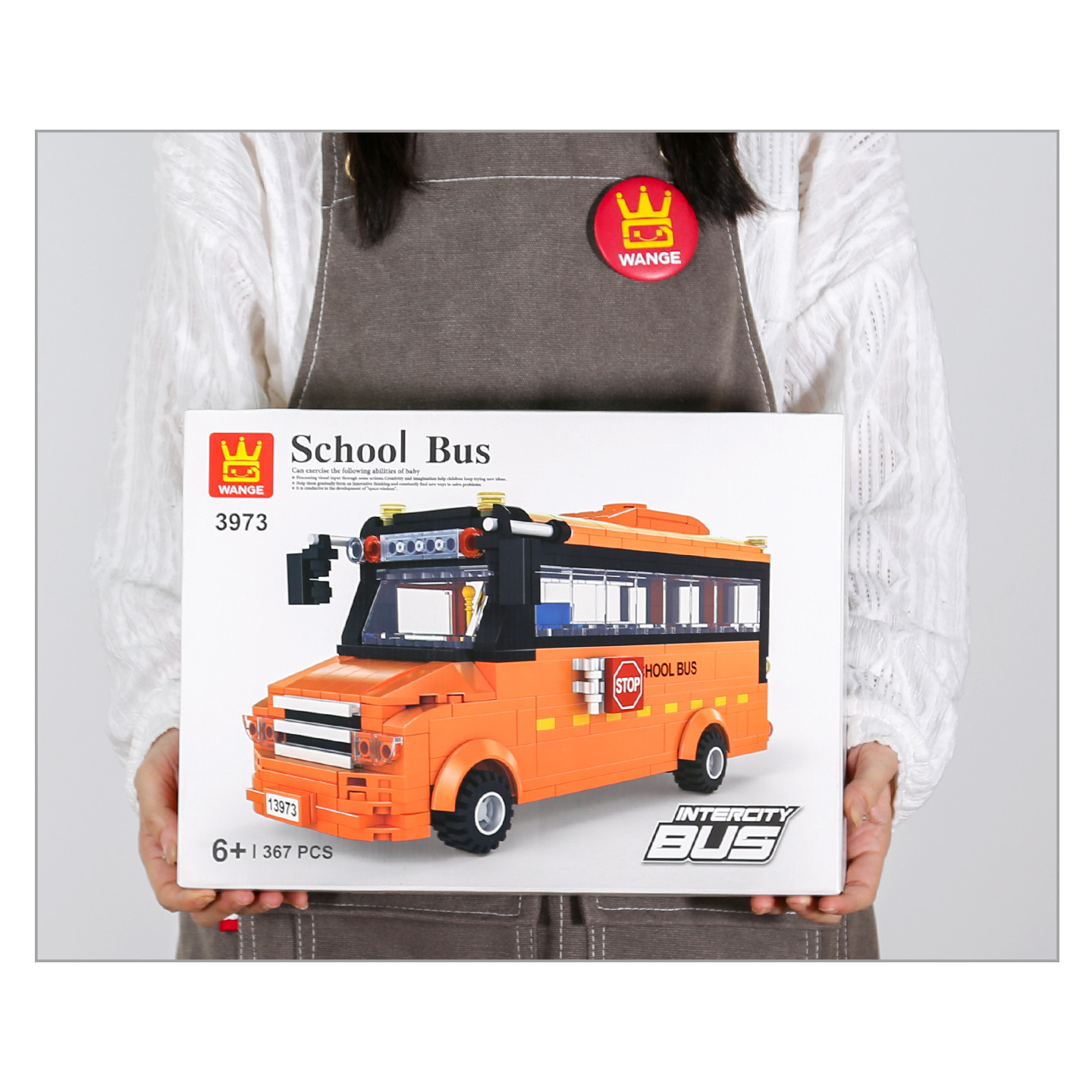 Box packaging of the WANGE School Bus building block set showing the completed orange bus model with transparent windows and realistic vehicle details