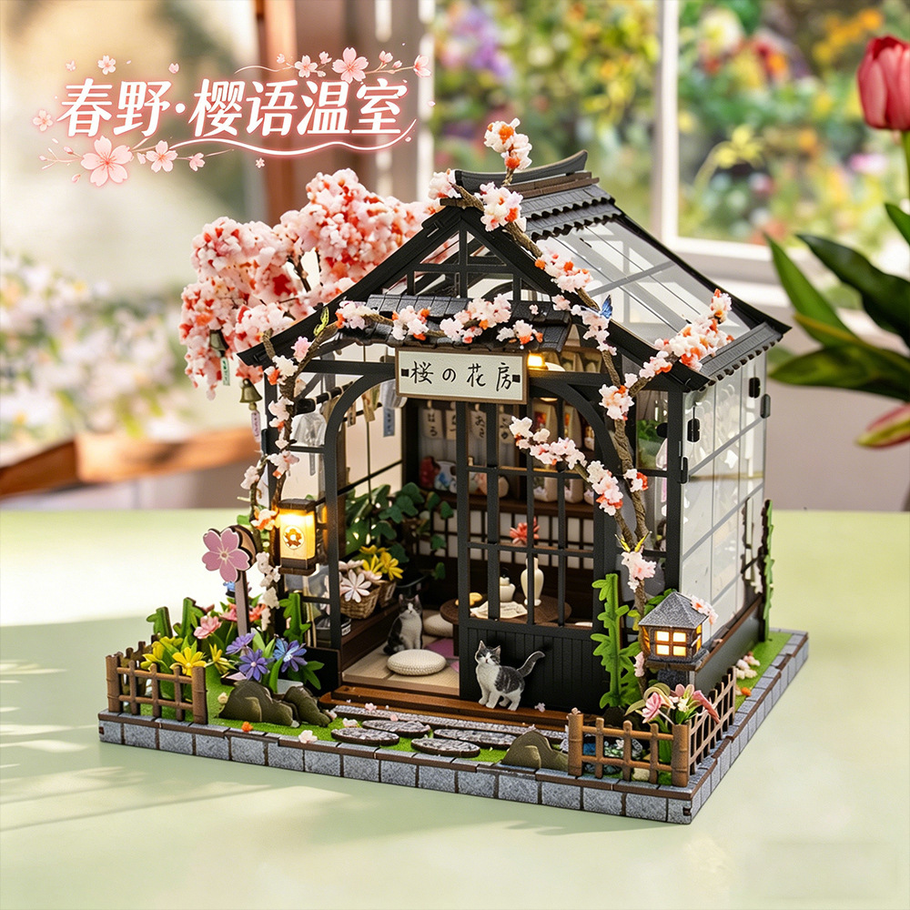 Japanese-style miniature greenhouse house with blooming sakura trees, warm LED lighting, transparent side panels, and detailed garden pathway display