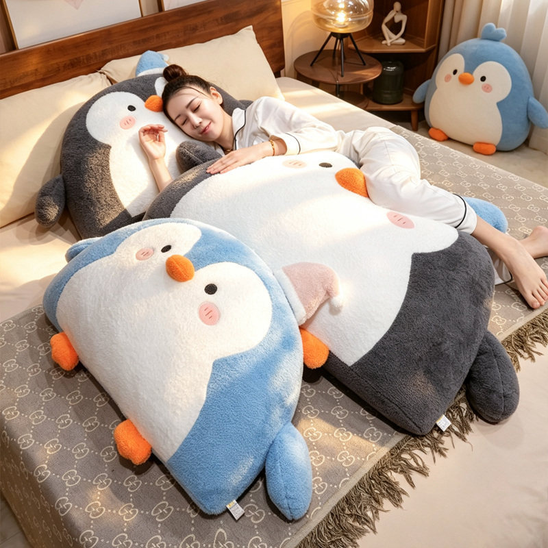 Penguin plush backrest pillows in gray and blue placed on a bed for cozy lounging, hugging, and bedroom decoration