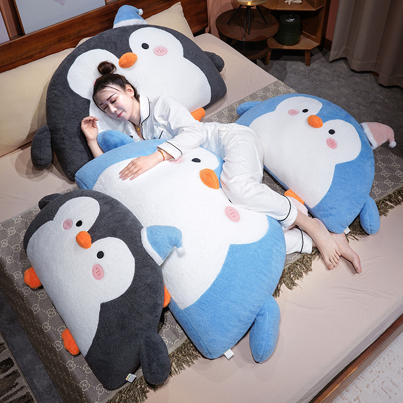 Gray and blue penguin plush backrest pillows on a bed for hugging, lounging, and cozy relaxation