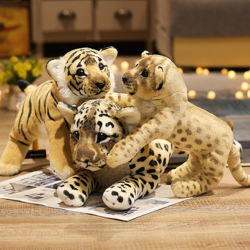Realistic leopard, tiger, and lion plush toys with detailed wildlife-inspired patterns and soft plush textures arranged in a cozy decorative display