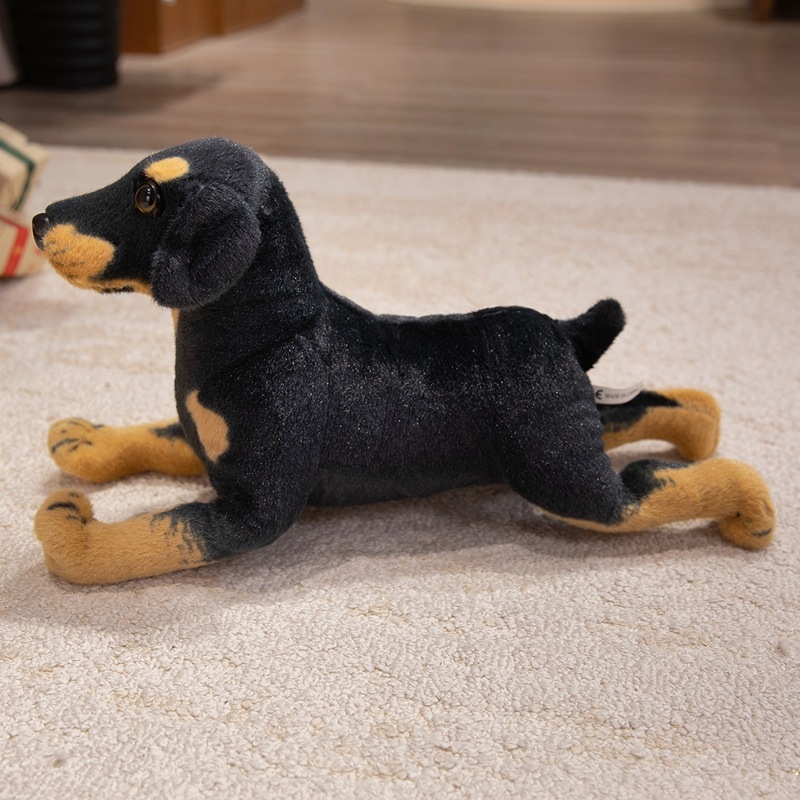 Realistic Rottweiler plush toy in a lying position with lifelike features and soft plush finish