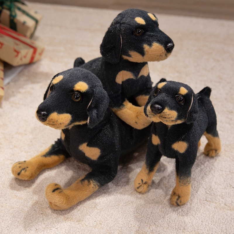 Realistic Rottweiler plush toys with lifelike black and tan markings displayed in a cozy indoor setting