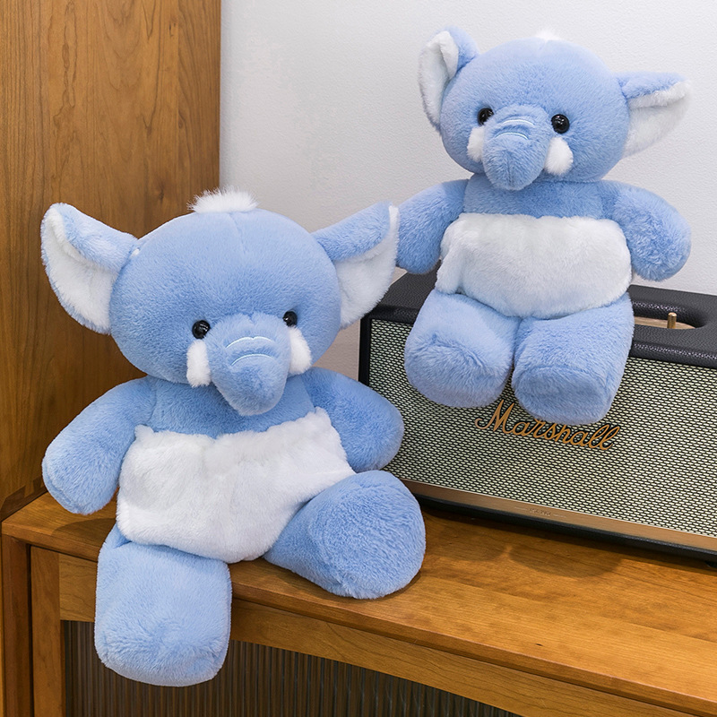 Blue elephant stuffed animal displayed on a shelf, showcasing its soft texture, gentle colors, and charming decorative appeal for bedrooms and living spaces