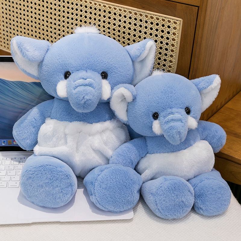 Blue Elephant Plush Toy beside a laptop, showcasing its soft plush texture and charming design for desk decor, relaxation, and everyday comfort