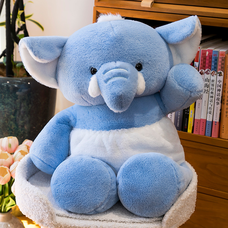 Blue elephant plush toy with soft plush texture, embroidered details, and a comforting design, displayed as a cozy decorative accent in a home setting