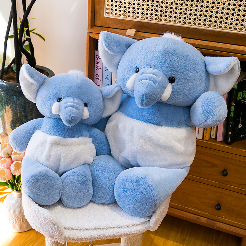 Blue elephant plush toy in two sizes displayed on a cozy chair, featuring soft plush fabric, floppy ears, and a cuddly design for bedrooms and living spaces