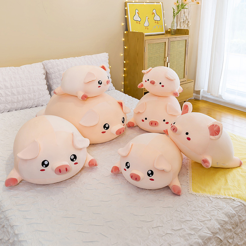 Round Pig Plush Pillow displayed in different sizes and eye styles on a bed