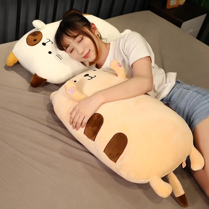 Brown Cat Plush Pillow used for cuddling and relaxing on a bed