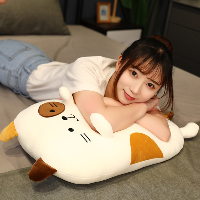 Calico Cat Plush Pillow used as a soft cushion for lounging, relaxing, and adding comfort to a cozy bedroom setting