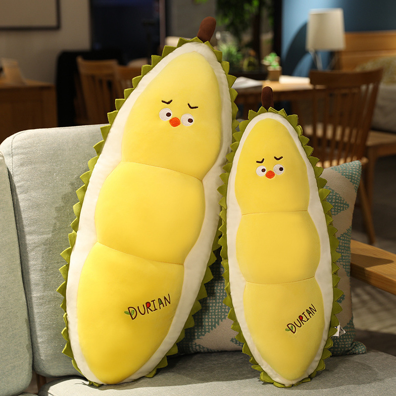 Durian Chick Plush Pillows in two sizes displayed on a sofa, showcasing soft plush fabric, playful character details, and available size options