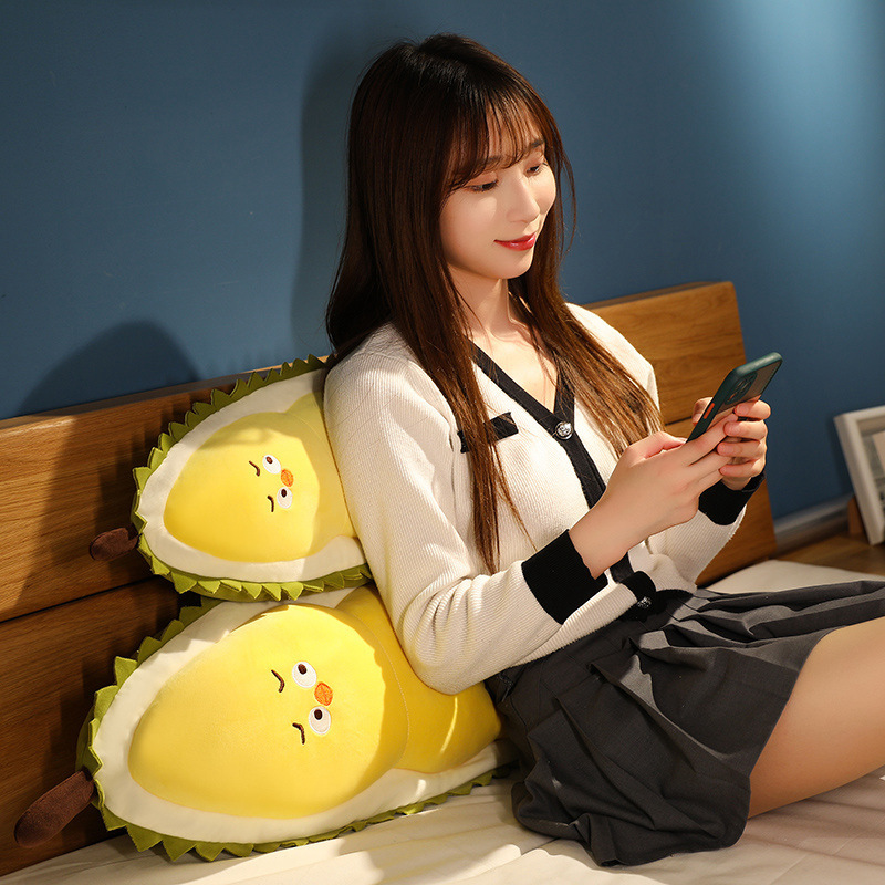 Durian Chick Plush Pillows used as back cushions on a bed, featuring a soft plush exterior and comfortable support for reading and relaxing