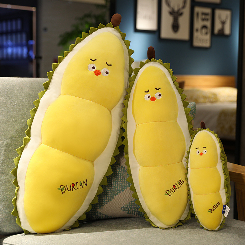 Durian Chick Plush Pillow in three sizes displayed on a sofa, featuring a cute chick face, durian-inspired shape, soft plush fabric, and cozy home decor appeal