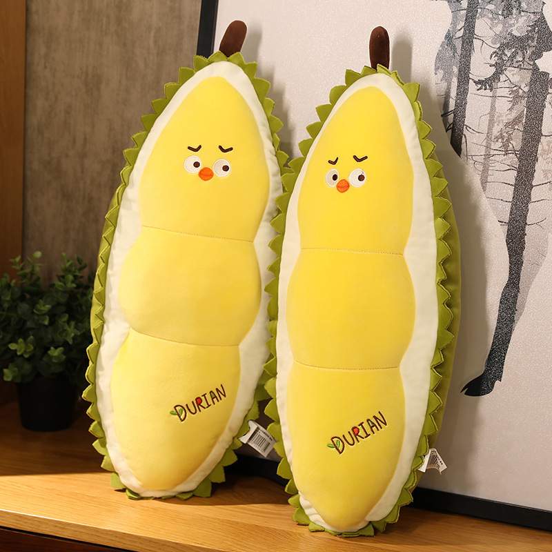 Durian Chick Plush Pillows displayed on a wooden shelf, showcasing soft plush fabric and a playful durian-inspired design