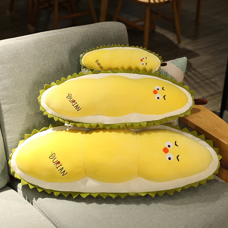 Durian Chick Plush Pillows arranged on a sofa, highlighting their cushioned shape, soft plush texture, and durian-inspired design details