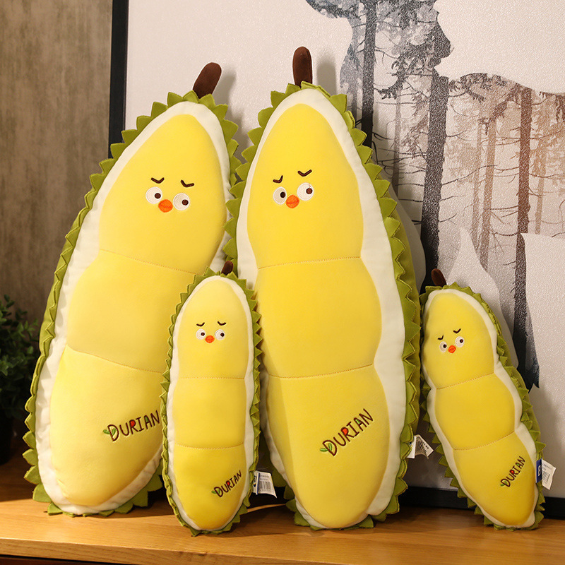Durian Chick Plush Pillows in multiple sizes displayed on a wooden shelf, highlighting size options and soft plush construction