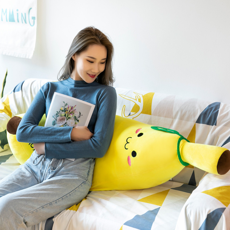 Banana Plush Pillow used as a soft backrest on a sofa, perfect for relaxing and reading